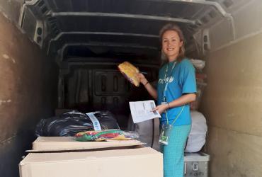 Marina Feher, a national UN Volunteer with the Blue Dot initiative of UNICEF and UNHCR in Romania, during a field visit. Working with women and youth refugees from Ukraine, Marina is seen here preparing protection products for distribution.