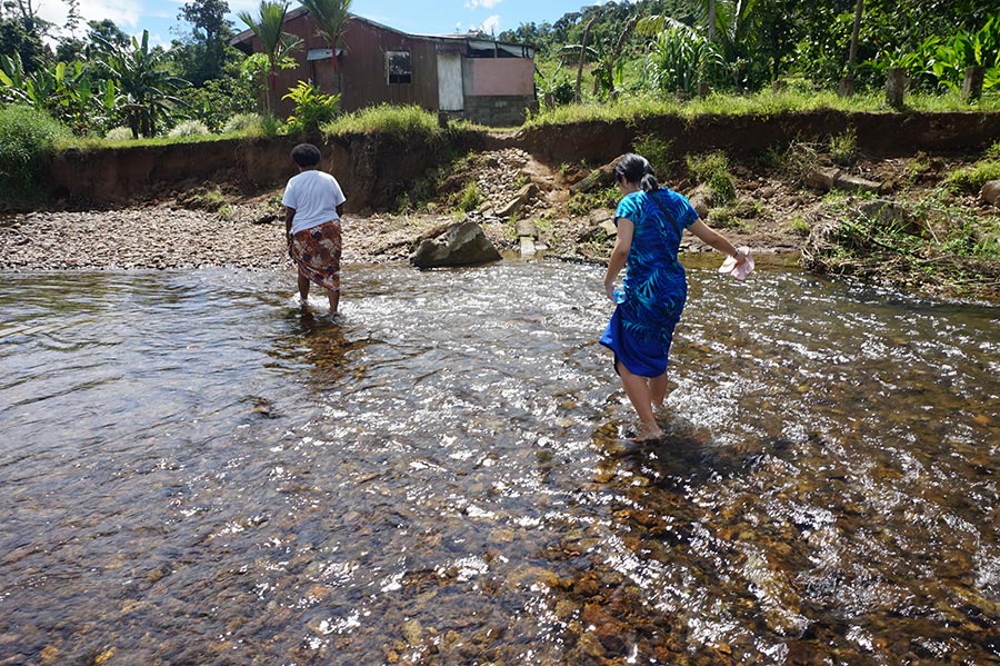 Fiji_Crossing_the_river_at_Nasau_village_in_Wainibuka_to_interview_M4C_participant_web.jpg