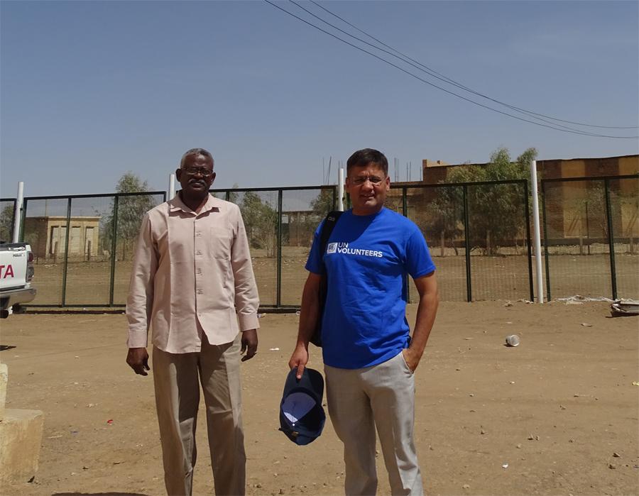 Photo: UN Volunteer Ali Sarwar (right) with a health worker from the State Ministry of Health during a data quality assessment mission in Kassala city. ©WHO Sudan, 2020.