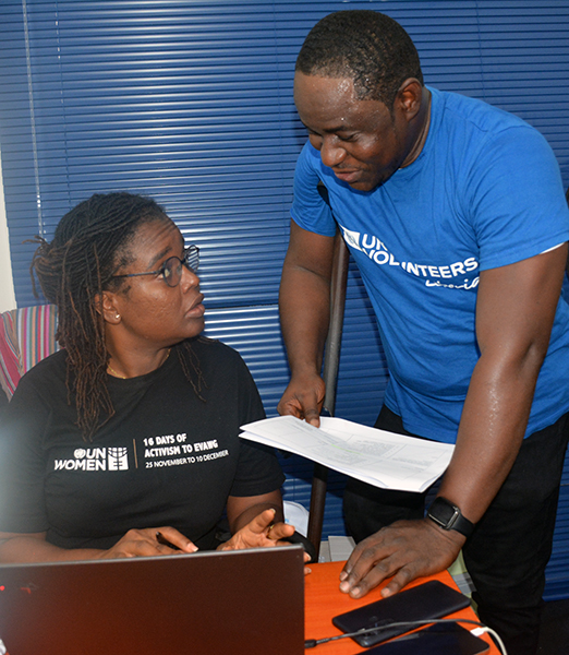 UN Volunteer Abraham V. Kanneh with a colleague in Liberia.