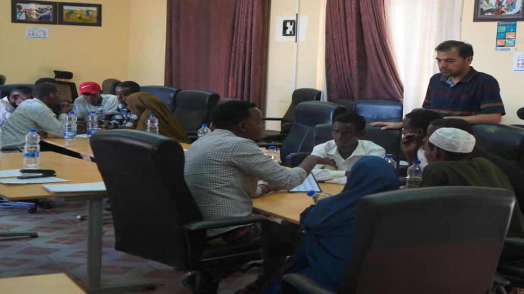 Muhammad Masood Shah (standing on the right), international UN Volunteer with UNHCR in Ethiopia leads Enumerator Training on Protection Monitoring Tool. © UNHCR Ethiopia, 2024