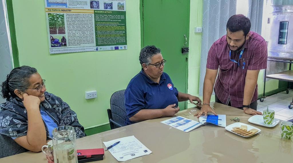 Karan Narayan (sitting on a nap in the middle), National UN Volunteer, Project Support Officer with UNCDF in Fiji explaining on the revised parametric insurance product to the staff of one of UNCDF’s new aggregator partner – Nature’s Way Cooperative.