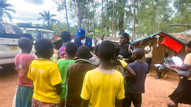 A group of children stand outdoors in Mangina, North Kivu, as UN and child protection staff facilitate their release from an armed group for reintegration support.
