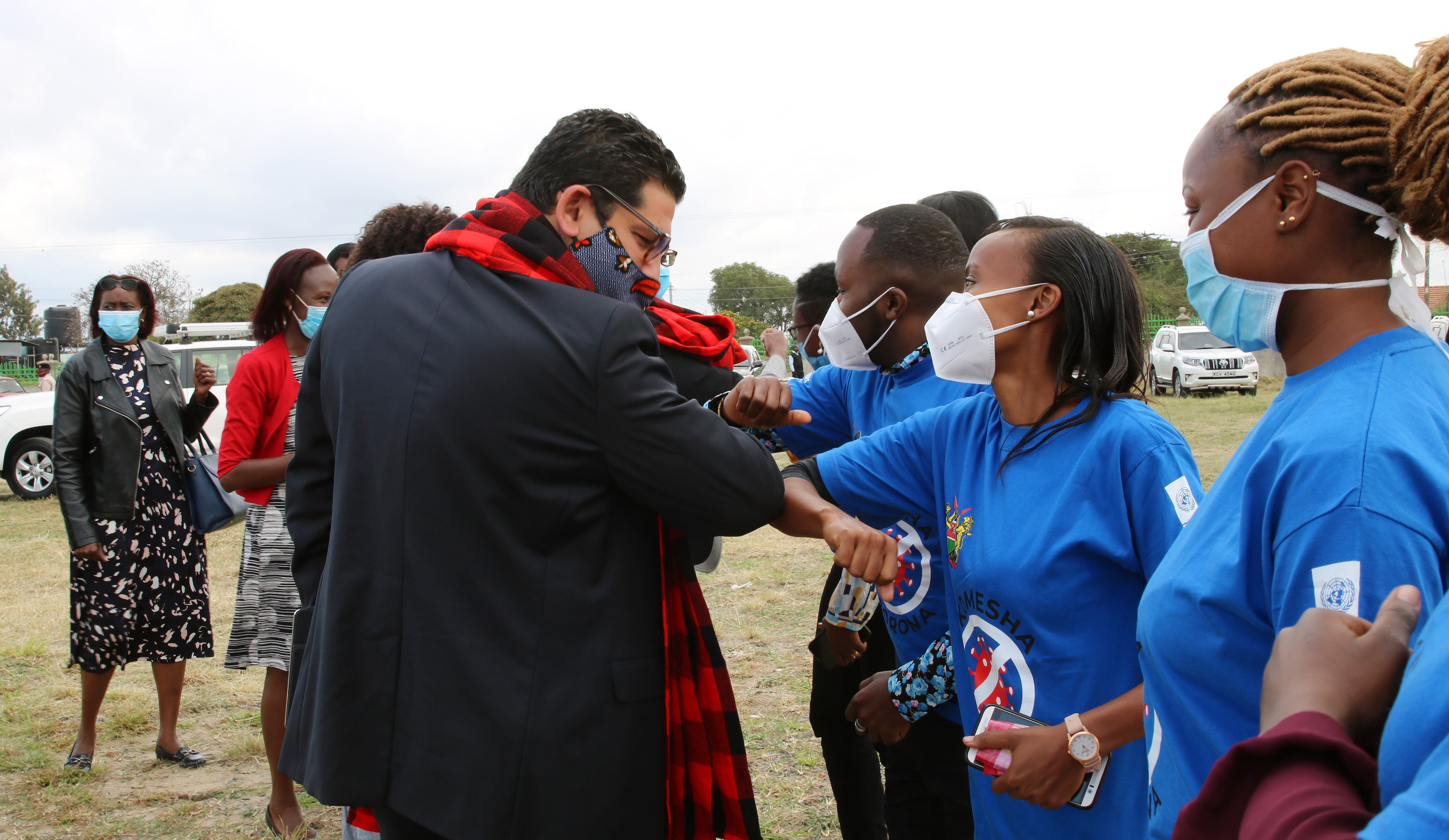 Walid Badawi  interacts with a section of UN Volunteers who supported COVID-19 response in Kenya.