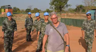 James Haddow, at the time a UN Volunteer with UNMISS, inspects fortifications in a mission camp in Wau, South Sudan. 