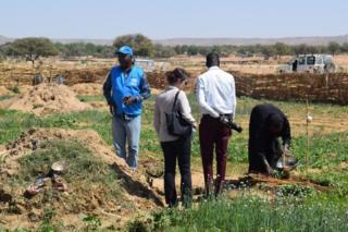 Sido Ide (left), UN Volunteer Water, Sanitation and Hygiene Specialist for surface water mobilization, supervises the technical assessment of Gaga market garden site for the benefit of refugees and host communities.