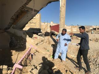Former UN Volunteer Danish Murad (right) surveys people affected by the floods in Quetta for the district administration, documenting damage to homes and infrastructure.
