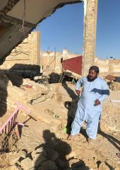 Former UN Volunteer Danish Murad (left) surveys people affected by the floods in Quetta for the district administration, documenting damage to homes and infrastructure. 