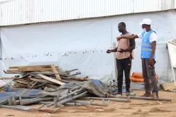 UN Volunteer Jonathan Biaback (right), who serves with WFP in Cameroon, supervises the set-up of a food distribution site in Minawao camp.