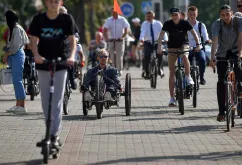 Sasha Audzevich, centre, plans to tour the world on his handcycle, to raise awareness about inclusion of people with disabilities.