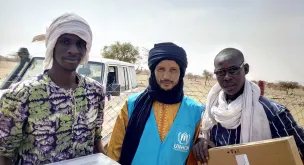 UN Volunteer UNHCR Oussamata Iba (centre), with two fellow refugees from the camp of Goudebou, Dori, Burkina Faso.