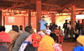 Gilbert Niyonkuru (centre), UN Volunteer assigned to UNDP in Burundi, during a community awareness activity on access to public services.