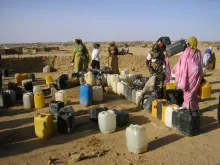 Sudanese refugee women prepare to fill their containers with precious water at a camp in eastern Chad.