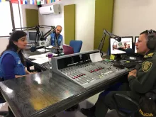 Marco Nardo, UN Volunteer Associate Protection Officer with UNHCR (centre), Vera Quina, Head of UNHCR Field Office of Mocoa (left) and Germain Bravo, Officer at the Putumayo National Police Department at the National Police Radio 93.2 FM, Mocoa, Colombia.