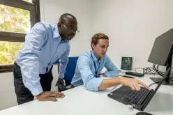 UN Volunteers Kyle Jacque (right) and Godfrey Mukalazi (left) consulting on activities for the “Support the Sudanese Peace Process” project.