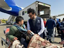 Ahmed Anas Awad, UN Volunteer, speaks to Palestinian patient being medically evacuated to Greece through the EU Civil Protection Mechanism.