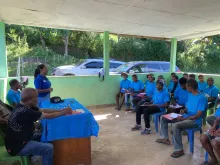 Fidelia Mendonca (standing), national UN Volunteer, Project Coordination Assistant with UNDP Timor Leste addresses the community in Ermera Municipality on services provided by the Spotlight Initiative including Access to Justice Clinic to support Domestic Violence and GBV survivors have access to the Formal Justice system.