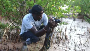 David Ouma, UN Volunteer Project Management Assistant, collects field stories for Nairobi Convention at Sabaki River, Kenya.
