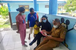 Rosyana Lievanty (second from right), national UN Volunteer Health Officer with UNICEF, checks documents at a public health center in Kupang District, Indonesia.