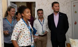 Toily KurbanovUNV Deputy Executive Coordinator Toily Kurbanov (right) and UNV Civil Engineer Gladys Gbegnedji (center-left) visit a newly rehabilitated home in Bartella, Iraq.
