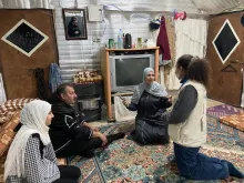 Noran Adly (Egypt), UN Volunteer Community Engagement Officer with UNICEF, visits a refugee family.