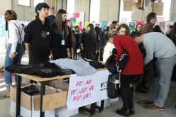 UN Youth Volunteer Minjoo Lee (left) with fellow volunteers at International Volunteer Day celebrations in 2019, welcoming participants to the exhibit and event.
