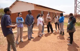 Zahra Vaziri (fourth from right), UN Volunteer Associate Programme Officer, during a field visit in Dzaleka Refugee Camp in Malawi.