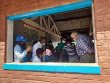 Dr Sibongile Chikombore (left) and her supervisor, Dr Bejoy Nambiar (right) engaging with the Chang'ambika Health team during a planning visit in Chikwawa district, Malawi.