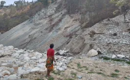 One of the victims, Shantu Maya Lama, looks at the remains of her house swept away by the floods.