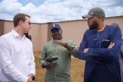 UN Volunteer, Dennis Bwala (center) speaks to representatives from the German Ministry of Foreign Affairs during a donor visit to the 152 houses built by UNDP in Jibia for the internally displaced persons.