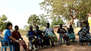Kei Tanaka, UN Volunteer with UNHCR, meets rice farmers at a refugee settlement in Uganda.