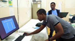 Alex Mkwamba, UN Volunteer Epidemiologist with UNDP, and Aleandro Ceita, a technician from the Health Information System department of the Ministry of Health, installing newly purchased computers at the Hospital Regional do Príncipe, São Tomé and Príncipe.