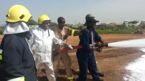 UN Volunteer Khurshid Dilresh (second from left) carries out basic firefighting training for Fire Safety Assistants.