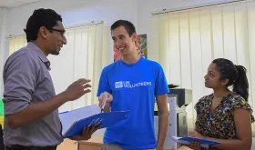 UN Volunteer Emergency Response Coordination Assistant, Alex Suwitra (Australia, centre) discussed humanitarian support in disaster situations with colleagues.