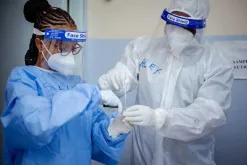 UN Volunteers Tabitha Shali (left), Nursing Officer, and Alex Munguti, Laboratory Technologist, prepare COVID-19 swabs for laboratory processing and analysis at Moi Referral Hospital, Voi, Taita Taveta County.
