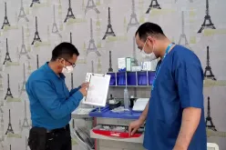National UN Volunteer Emergency Nurse Ahmed Al Rough (left), checking a list of critical emergency medications at UN clinic in Sana'a, Yemen.