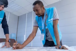 Abdelmohsin Elzair, international UN Volunteer Expert Supervising Engineer with UN-Habitat, inspects a drawing of a project site plan in Basra, Iraq.