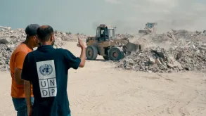 UN Volunteer Field Engineers Hussein AlWasifi (left) and Mohammed Alghouti (right) during on-site debris removal in Gaza.
