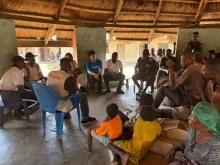 UN Volunteer Protection Officer Gakuto Han listens to residents describing their needs and concerns during a meeting in Abagena, Agan Council Ward in Makurdi. His volunteer assignment is funded by Japan.