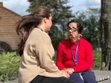 Vibhu Sharma (right) UN Volunteer Communications Specialist for Disability Inclusion speaks to a fellow UN Volunteer while visiting UNV Headquarters in Bonn.