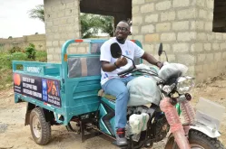 Samuel Peprah Bekoe, UN Volunteer Field Coordinator, en route to deliver a tricycle to a YAI beneficiary in Wonoo, Ashanti Region, empowering her to boost sales and expand her business.