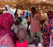 Dr. Mahamadou Nouri Kassimoune Tago, UN Volunteer Specialist, conducts a routine vaccination monitoring session at a WHO vaccination site.