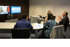 Mr Olivier Adam, UNV Executive Coordinator (far right), and Mr Alan AtKisson, Head of the Department for Partnerships, Sida (on screen), and their teams discuss the partnership between UNV and Sweden.