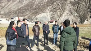 UN Volunteer Zeng Yunheng (China) during a field visit to local farms with agricultural experts in Zhouqu in January 2020