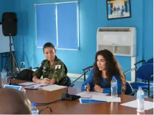 Karima Amadi (right) UN Volunteer Support Officer with the United Nations Mission in South Sudan speaks at a gender equality meeting.