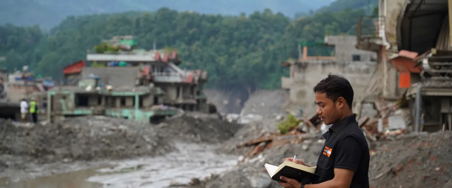 A UN Volunteer with the United Nations Population Fund, Ashok Chaudhary, assesses flood-affected Nuwakot and Rasuwa Districts for emergency supply distribution in early September 2026.