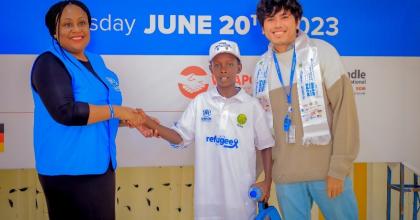Denny Beryan Saputra, international UN Volunteer Specialist Associate Operational Data Management Officer (right) during a UNHCR organized art contest on World Refugee Day on 20 June 2023. The children showcased their creativity through the power of art to connect, empower, and inspire. 