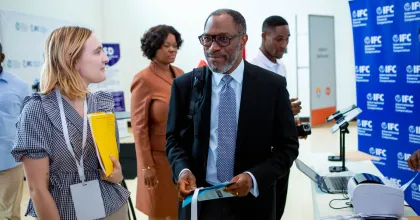 Alissa (left), UN Volunteer Operations Analyst with IFC, exchanges with a colleague during the Country Investment Review and Analysis (CIRA) dissemination event.
