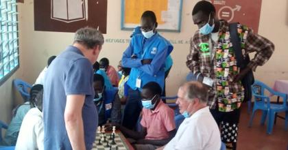 John Mariak Manyuon (centre), Refugee UN Volunteer Activities Coordinator with UNHCR Kenya, during the visit of the president of the International Chess Federation (FIDE) to the youth chess project in Kakuma and Kalobeyei settlements, held at Angelina Jolie Girls Primary School student Hall.