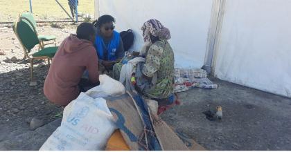 Lynn Karanja (in blue jacket), Associate Mental Health and Psychosocial Support Officer, UNHCR Ethiopia engages with a refugee woman in Alemwach Refugee Site to identify her needs and link her with the appropriate services. 